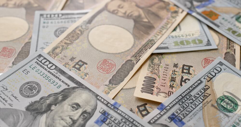 Dollar and Yen bills. USD/JPY